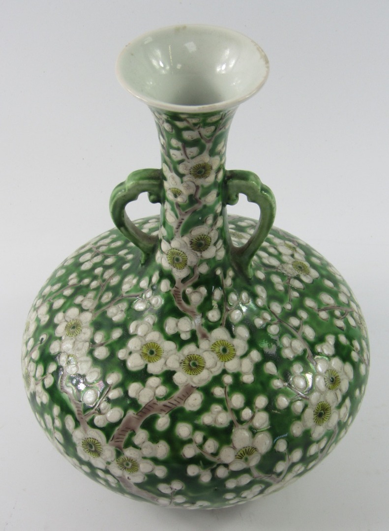 Appraisal: Chinese earthenware green glazed vase raised with various flower heads