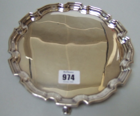 Appraisal: A silver shaped circular salver raised on four scrolling feet