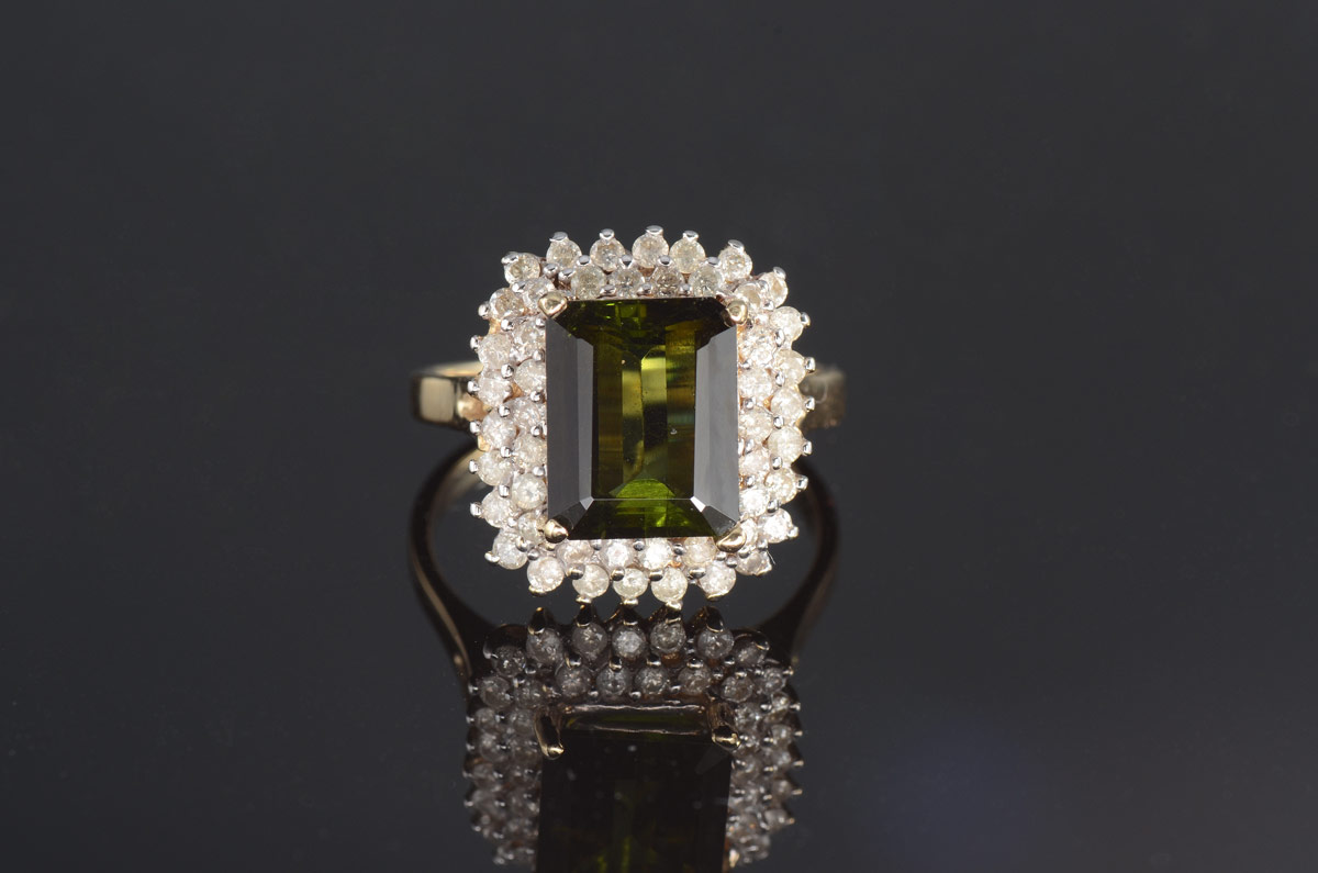 Appraisal: K TOURMALINE DIAMOND RING K yellow gold ring contains one