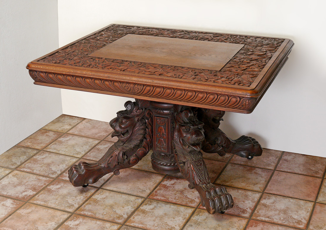 Appraisal: BATTLE SCENE CARVED LION PEDESTAL TABLE Top framed with carved