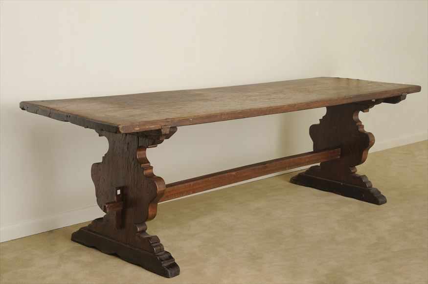 Appraisal: ITALIAN BAROQUE WALNUT TRESTLE TABLE The rectangular top on shaped