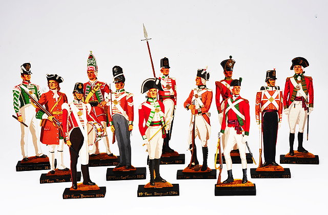 Appraisal: A GROUP OF TWELVE CUT WOODEN SOLDIERS each hand painted