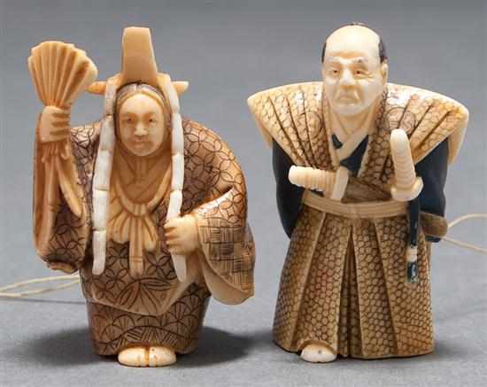 Appraisal: Two Japanese carved ivory netsukes woman in ceremonial garb and