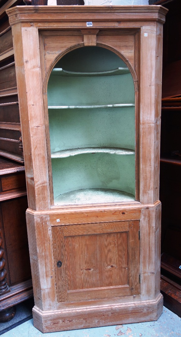 Appraisal: A late George III pine double height corner cupboard with