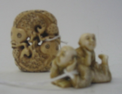 Appraisal: TWO JAPANESE IVORY CARVED NETSUKE the first depicts a male