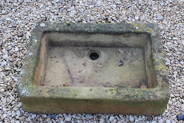 Appraisal: A SHALLOW STONE SINK with rounded front corners cm x