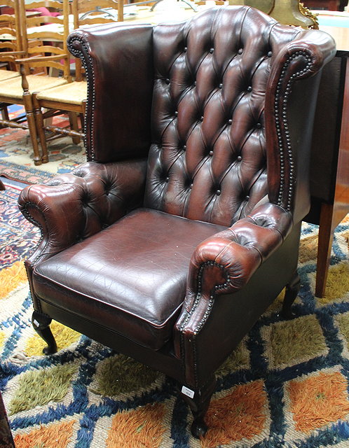 Appraisal: A LATE TH CENTURY LEATHERETTE BUTTON UPHOLSTERED WING BACK ARMCHAIR