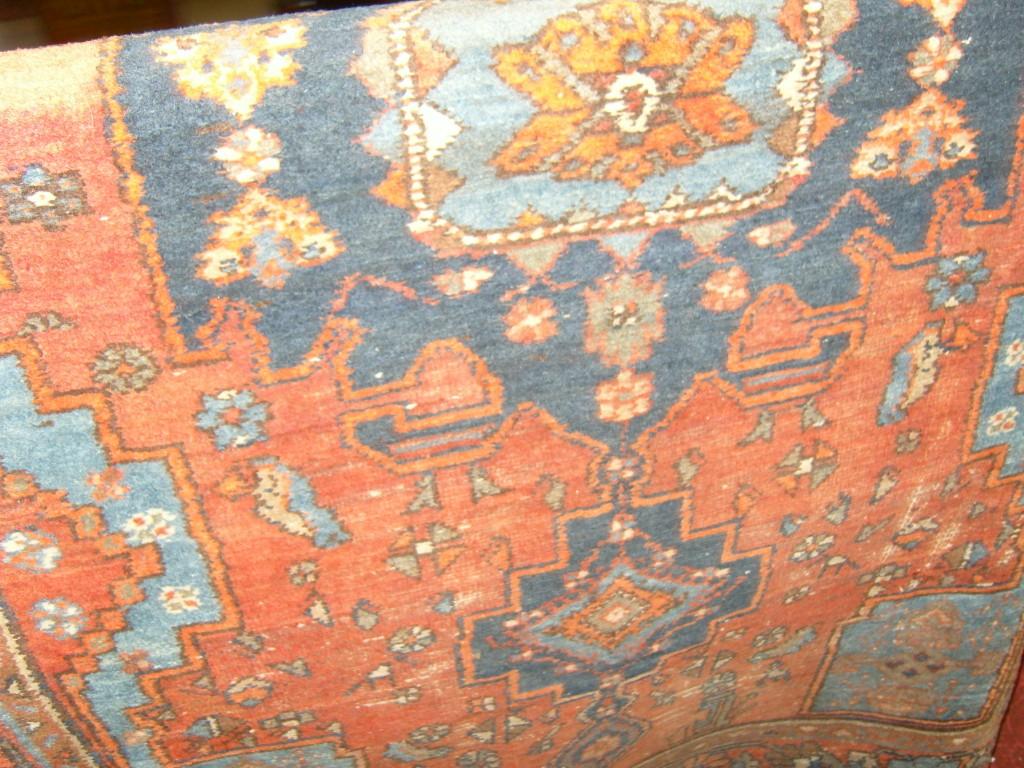 Appraisal: A red ground eastern wool rug with geometric decoration in