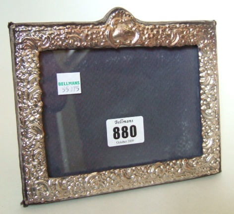 Appraisal: A silver mounted shaped rectangular photograph frame with floral and