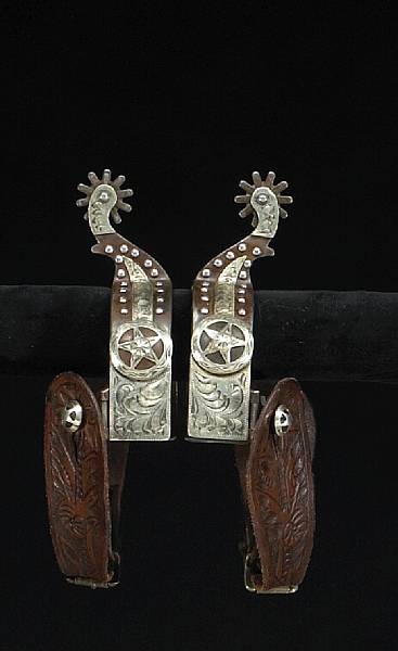 Appraisal: A pair of silver-mounted Texas style spurs Wide heel bands