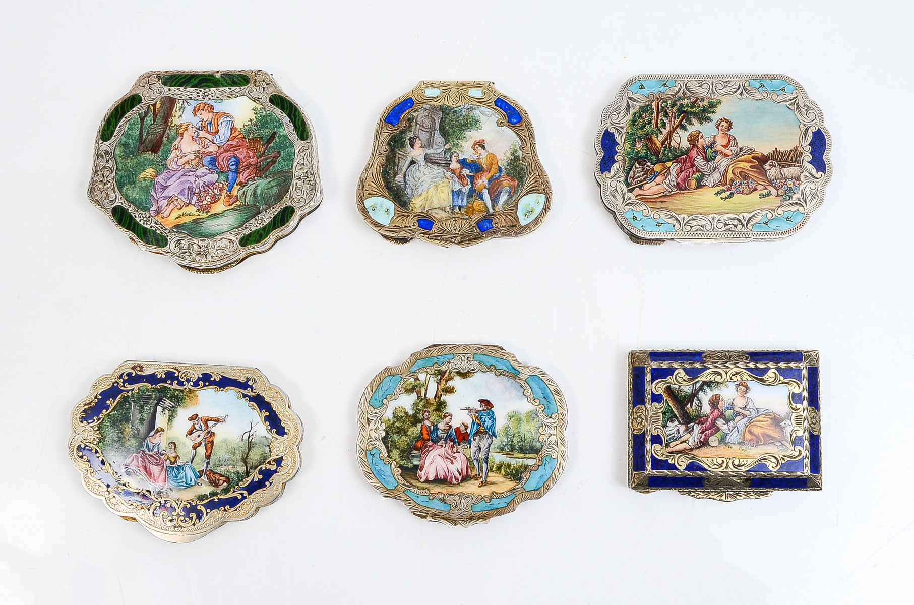 Appraisal: CONTINENTAL ENAMELED GILT SILVER COMPACTS Compact with romantic scene with