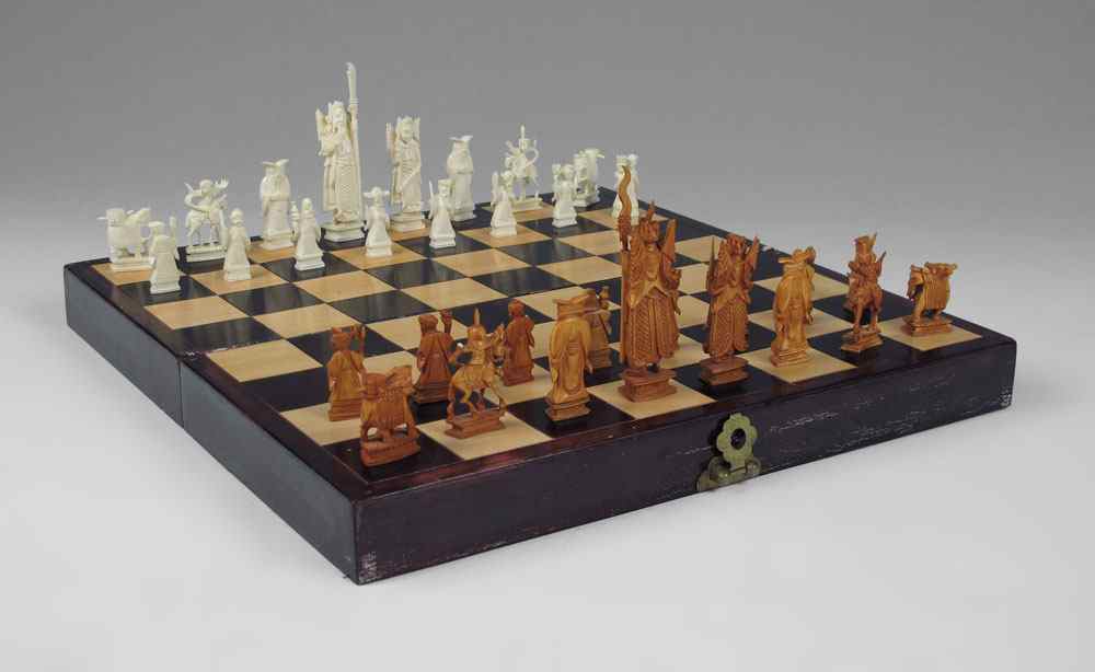 Appraisal: CARVED IVORY CHESS SET IN GAME BOX Chinese carved ivory