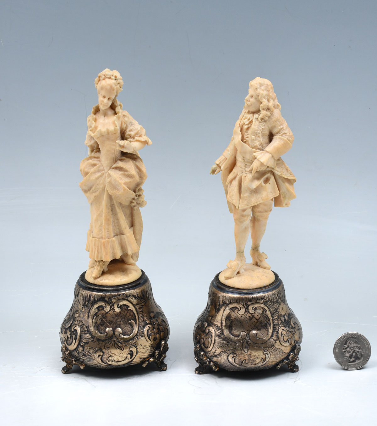 Appraisal: CARVED CONTINENTAL IVORY FIGURES ON SILVER STANDS Continental male female