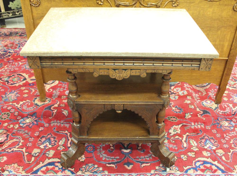 Appraisal: VICTORIAN MARBLE-TOP WALNUT LAMP TABLE Charles Eastlake design American last