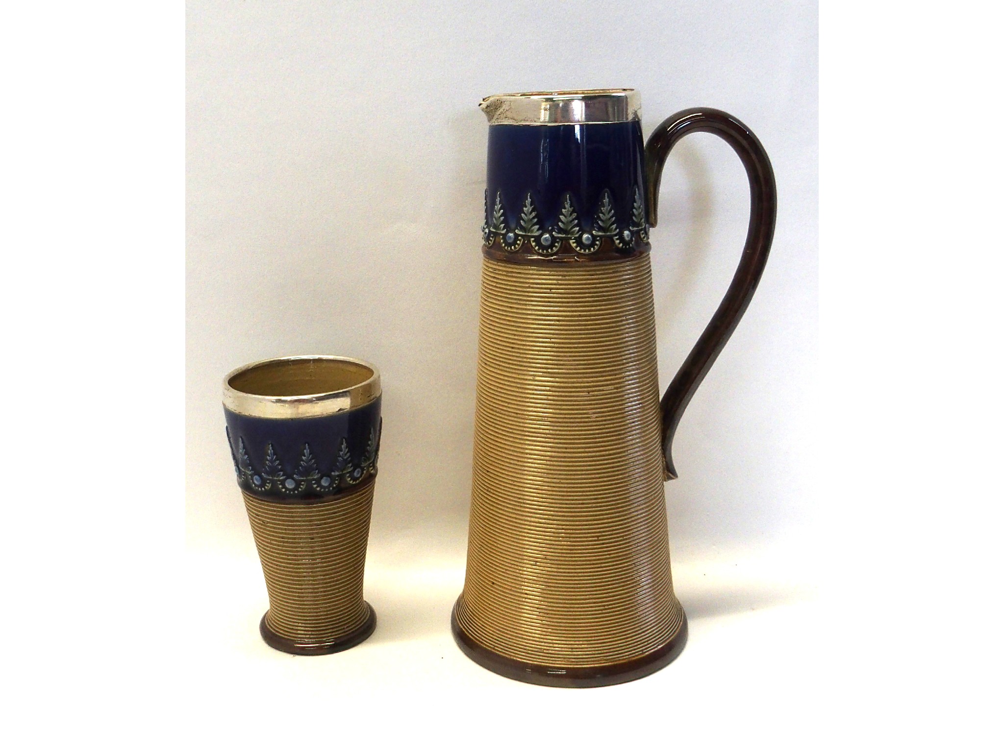 Appraisal: Doulton Lambeth stoneware jug and mug with silver rims