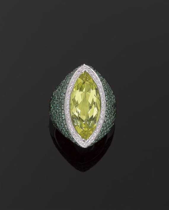 Appraisal: PERIDOT TSAVORITE AND BRILLIANT-CUT DIAMOND RING White gold Fancy modern