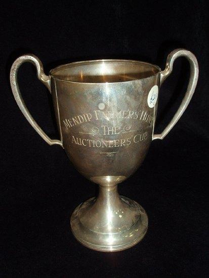 Appraisal: A trophy cup of goblet form with loop handles on