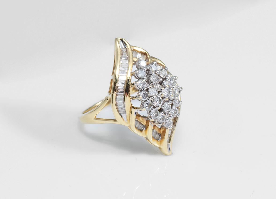 Appraisal: DIAMOND COCKTAIL RING K yellow gold ring contains round brilliant