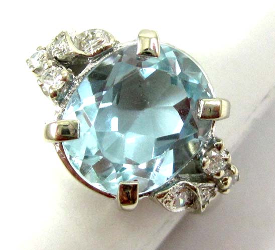 Appraisal: AQUAMARINE AND FOURTEEN KARAT WHITE GOLD RING with four round-cut