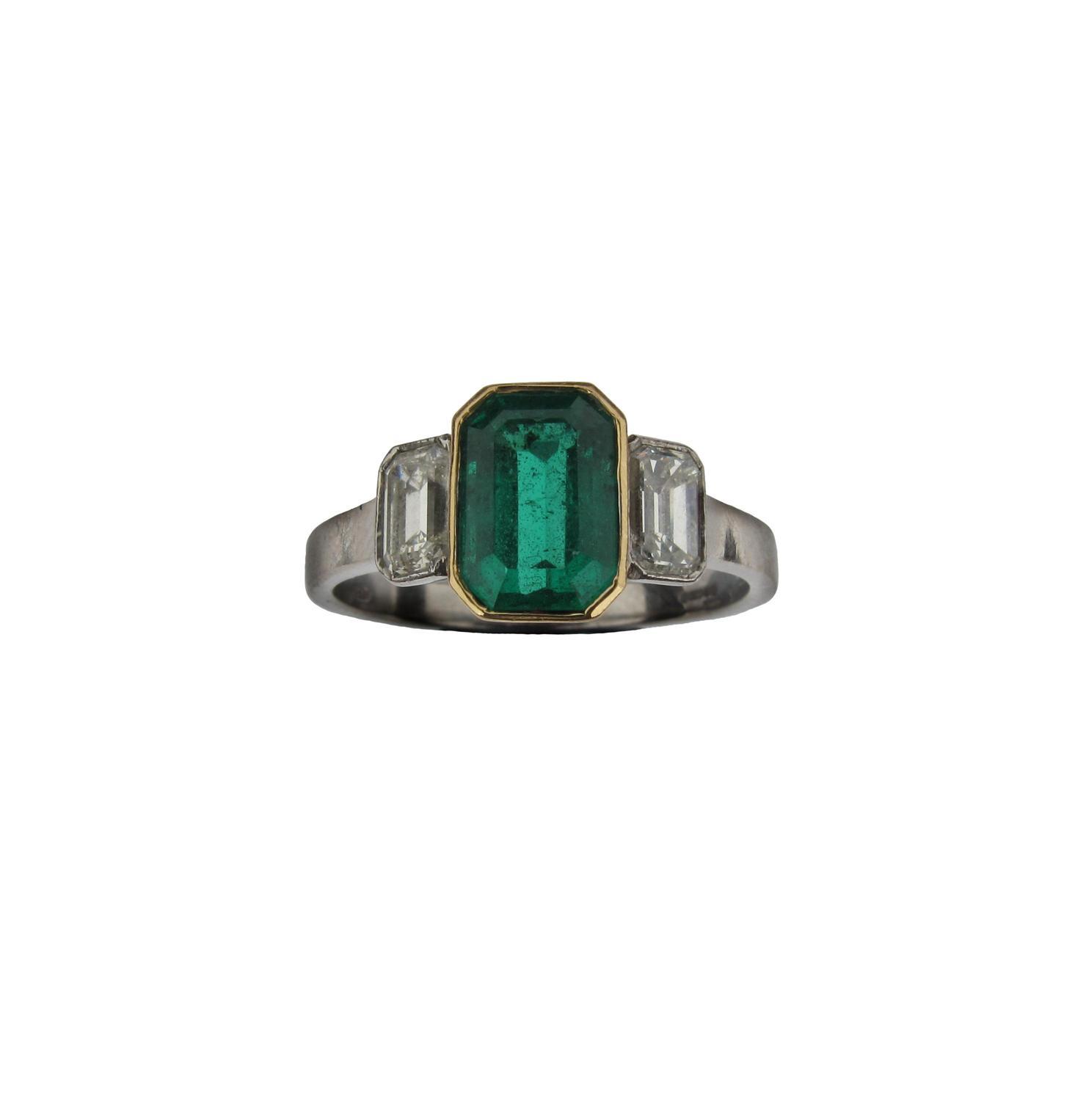 Appraisal: An emerald and diamond three stone ring