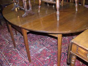 Appraisal: An oak drop leaf table th century the oval top