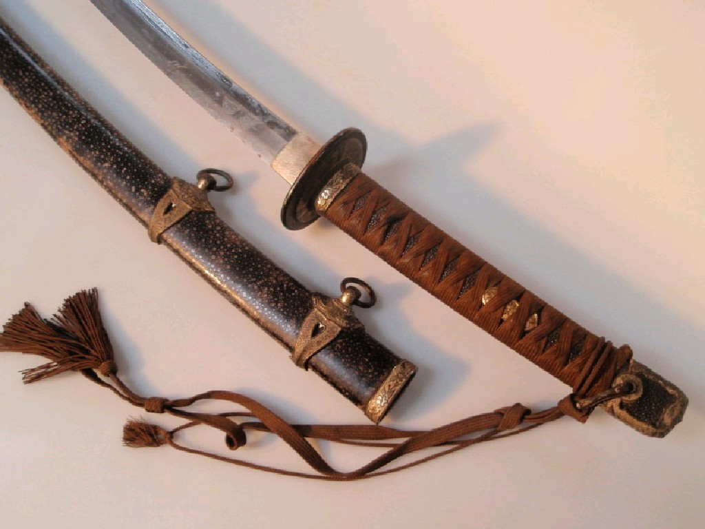 Appraisal: A thC Japanese katana with shagreen bound scabbard and ornate