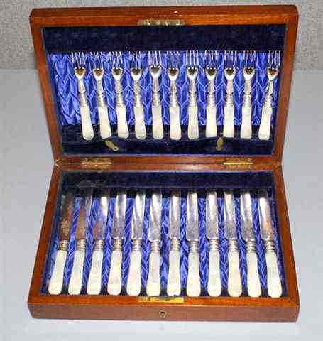 Appraisal: A CASED SET OF TWELVE IVORY HANDLE FISH KNIVES FORKS