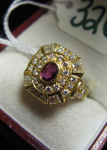 Appraisal: RUBY DIAMOND AND EIGHTEEN KARAT GOLD RING centering an oval-cut