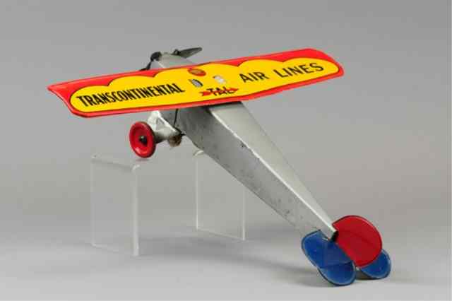 Appraisal: GIRARD TRANSCONTINENTAL AIRLINES Tinplate single wing airplane lithographed tin wing