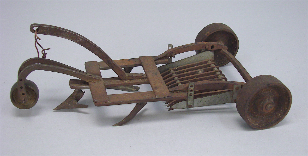 Appraisal: SMALL METAL MULTI-BLADE PLOW ATTACHMENT Possibly a salesman's sample Three