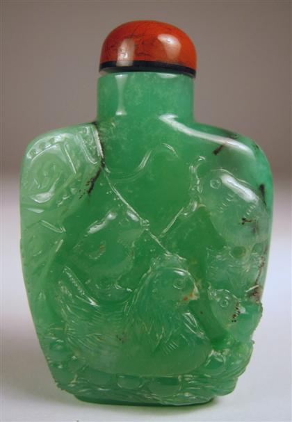 Appraisal: Chinese apple green jadeite snuff bottle The rectangular bottle carved