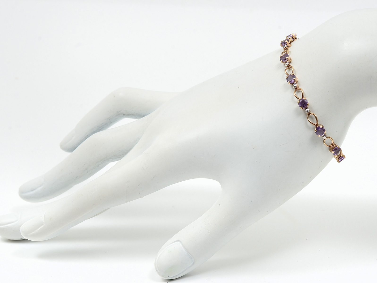 Appraisal: K AMETHYST DIAMOND BRACELET amethysts and diamonds are set in