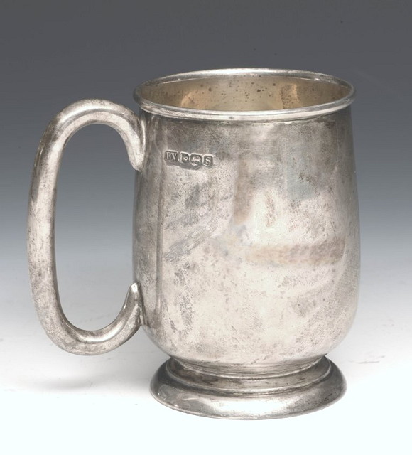 Appraisal: A SMALL SILVER MUG of baluster form on pedestal foot