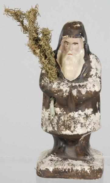 Appraisal: Belsnickel Chalkware Santa Description Folded arms holding fir tree with