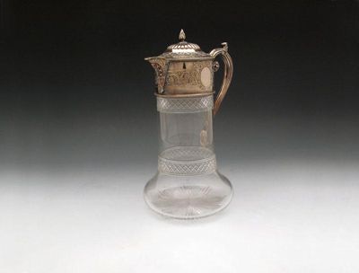 Appraisal: An electroplated mounted claret jug of tapering and circular bellied