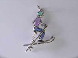 Appraisal: A platinum diamond amethyst sapphire and emerald set skier charm