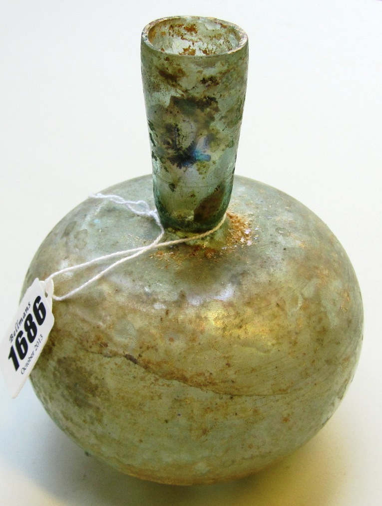 Appraisal: A pale green Roman glass bottle the spherical body with