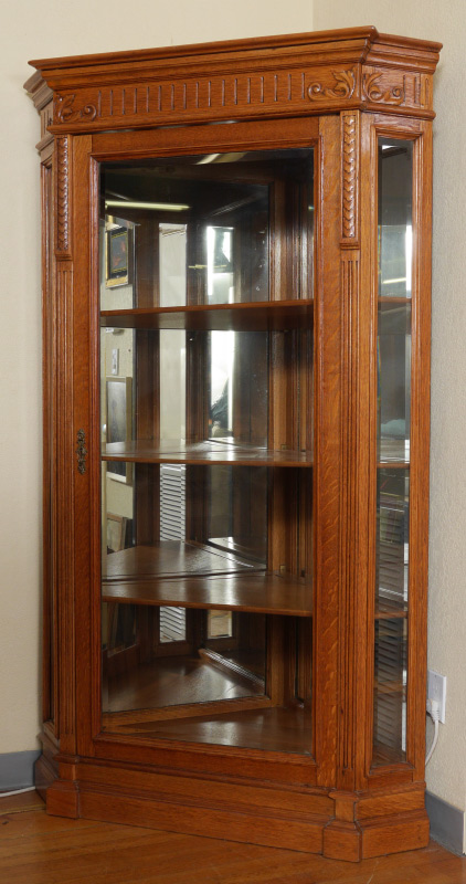 Appraisal: EASTLAKE CARVED GOLDEN OAK CORNER DISPLAY CABINET Carved crest over