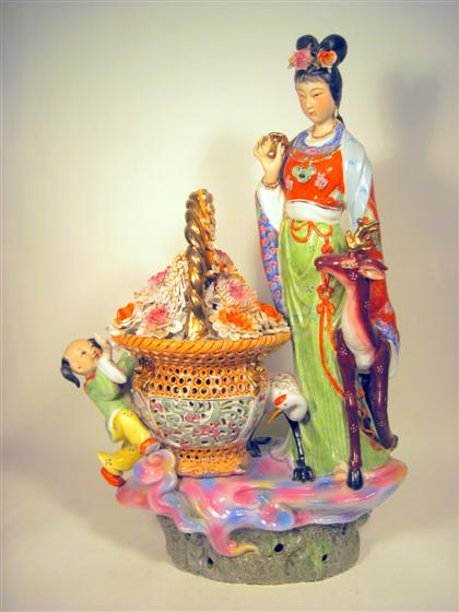 Appraisal: Large Chinese porcelain groupingModeled as a female beauty holding a