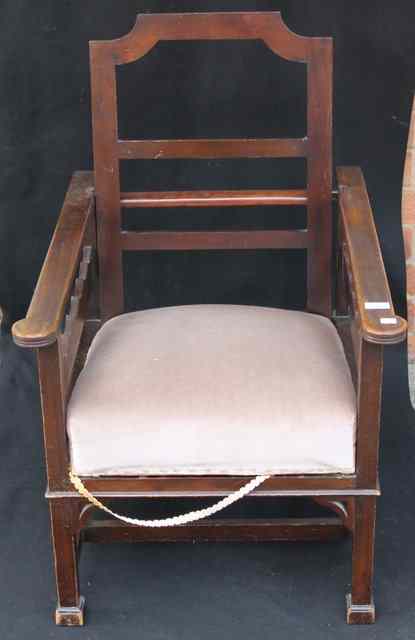 Appraisal: AN EDWARDIAN WALNUT EASY CHAIR of square cut form with