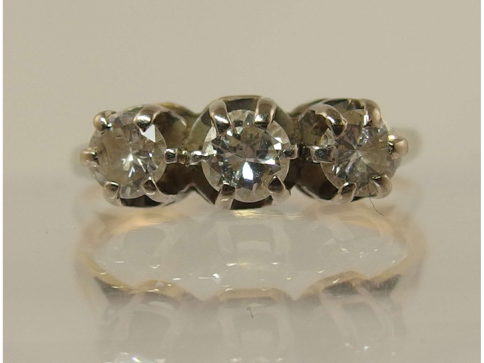 Appraisal: An ct three stone diamond ring with a combined total