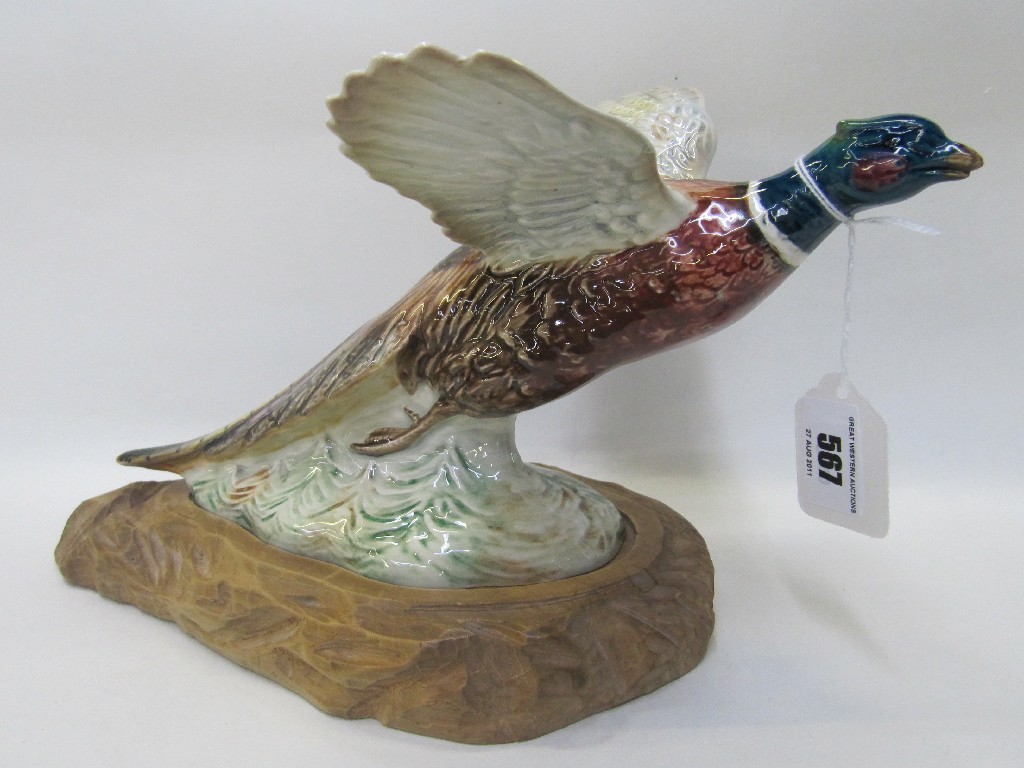 Appraisal: Beswick pheasant on carved wooden base no