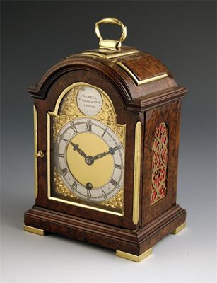 Appraisal: A burr walnut miniature mantel clock with an English platform