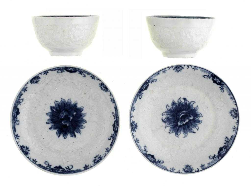 Appraisal: A PAIR OF WORCESTER MOULDED TEA BOWLS AND SAUCERS painted