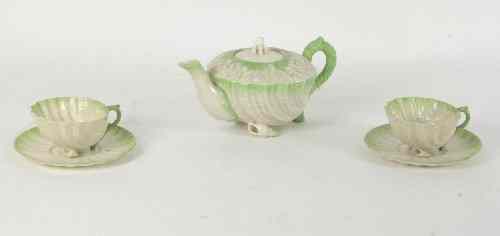 Appraisal: A Belleek teapot and cover of shell form encrusted with