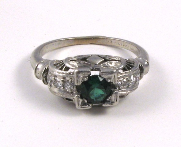 Appraisal: TSAVORITE AND EIGHTEEN KARAT GOLD RING centering a round-cut green