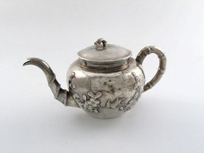 Appraisal: A Chinese silver tea pot circular form embossed with birds