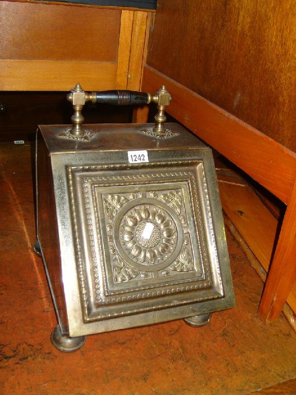 Appraisal: An Edwardian anodised coal box the rising lid with relief