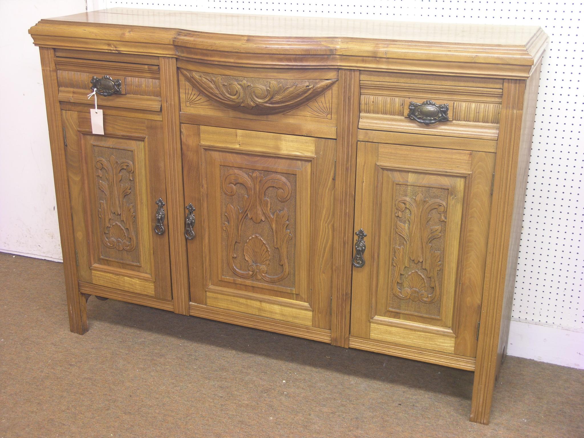 Appraisal: A late Victorian carved walnut sideboard two drawers above three