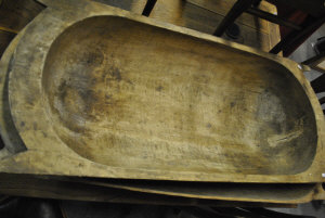 Appraisal: A pair of tribal carved dug-out food troughs with carrying